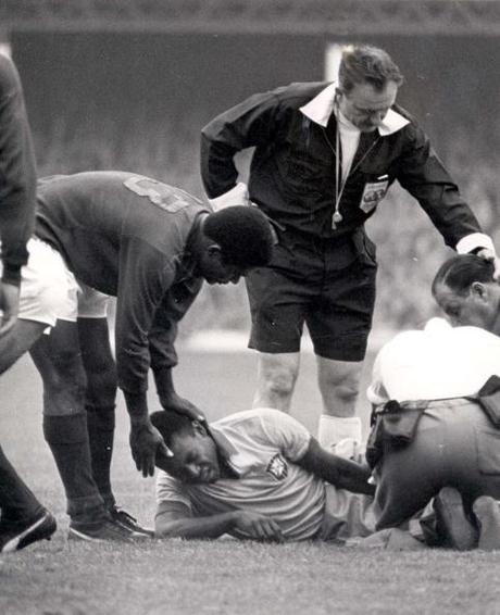 World Cup Finals, 1966. Liverpool, England. 19th July, 1966. Portugal 3 v Brazil 1. Portugal's Eusebio holds the head of Brazilian star Pele, seen in agony on the ground after being injured in a tackle during their Group Three match.