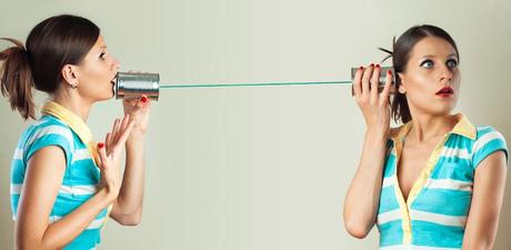 a young woman talking to herself on the tin can phone