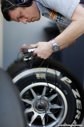 A Pirelli engineer is checking the degradation levels