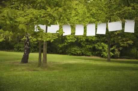 Istock foto blank paper sheet hanging on a rope in garden