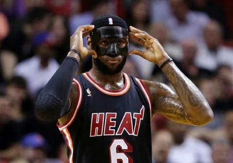 Miami Heat small forward LeBron James adjusts his mask - Copyright AP Photo/Alan Diaz