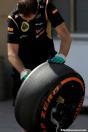 A Lotus F1 team mechanic is cleaning a P Zero Orange hard tyre Report Pirelli: F1 Test 2014 Bahrain 2