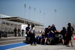 Valtteri Bottas Williams is being pushed into the garage while a female Pirelli engineer looks on Report Pirelli: F1 Test 2014 Bahrain 2