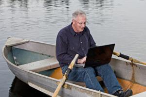 Mature Man working on computer outside
