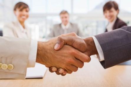 Portrait of happy businesspeople shaking hands