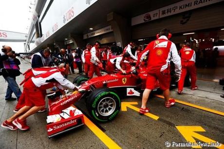 Raikkonen is pushed back into the garage during practice