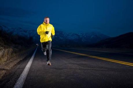 Man running on the road at night in Emigration Canyon near Salt Lake City, Utah