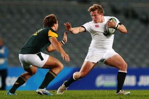 AUCKLAND, NEW ZEALAND - JUNE 20:  Tom Woolstencroft of England fends against Andre Esterhuizen of South Africa during the 2014 Junior World Championship Final match between England and South Africa at Eden Park on June 20, 2014 in Auckland, New Zealand.  (Photo by Anthony Au-Yeung/Getty Images)