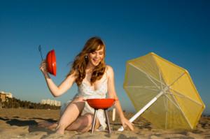 woman grilling on beach