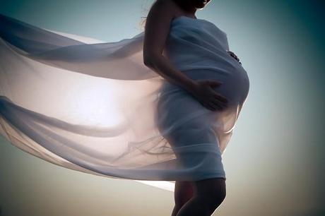 Pregnant woman wrapped in veil