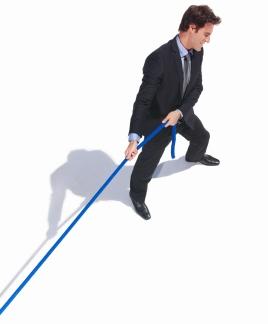 Top view of a business man pulling a rope isolated on white background