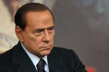 Italian Prime Minister Silvio Berlusconi listens to a reporter's question during a news conference at Chigi palace in Rome