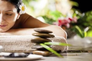 Smiling woman receiving massage at the spa resort.