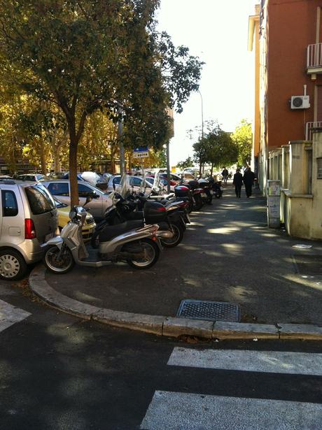 Forse è il caso di piantarla di posteggiare i motorini sul marciapiede? Forse è il caso di iniziare a multare seriamente questa infrazione?