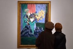 People look at a painting by French artist Henri Matisse during a press preview of the exhibition 
