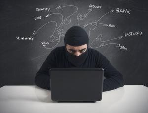 Concept of hacker at work with laptop