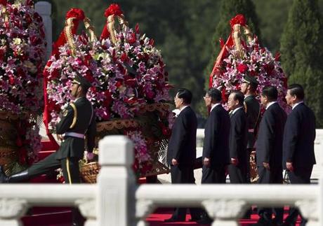 Chinese Paramilitary policemen carry flowers led China's leaders from center to right, President Hu Jintao, Head of Legislature Wu Bangguo, Premier Wen Jiabao, Chairman of Chinese People's Political Consultative Conference Jia Qinglin, and Vice President Xi Jinping as they pay visit to Monument to the People's Heroes during the National Day's ceremony at Tiananmen Square in Beijing Monday, Oct. 1, 2012. (AP Photo/Andy Wong)