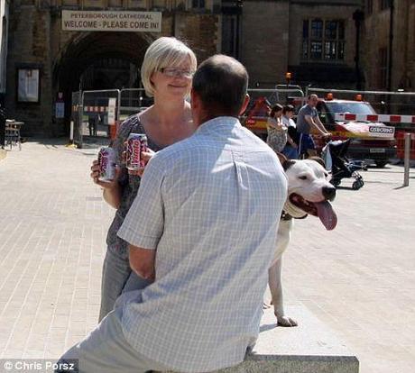 Now: The couple - now with a different dog - recreate their  classic picture