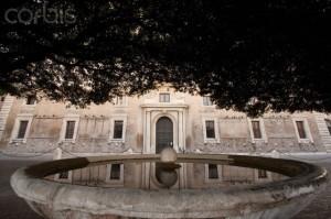 Villa Medici is reflected in the fountain's still waters.