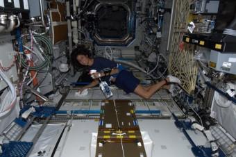 L'astronauta statunitense Sunita Williams armata di spruzzino e strofinaccio, pronta a far le pulizie a bordo della ISS.