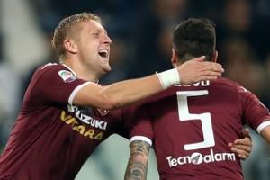 Torino's Italian defender Cesare Bovo (R) celebrates with Torino's Polish defender Kamil Glik during the Italian Serie A  football match between Juventus and Torino on October 31, 2015 at the 