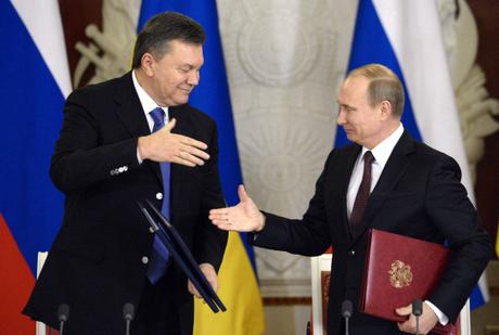 Russia's President Vladimir Putin (R) and Ukrainian President Viktor Yanukovych shake hands after signing documents during their meeting in the Kremlin in Moscow, on December 17, 2013. Putin said that the state energy companies of Russia and Ukraine had signed an amended agreement slashing the price Moscow charges its cash-strapped neighbour for natural gas. AFP PHOTO / ALEXANDER NEMENOV (Photo credit should read ALEXANDER NEMENOV/AFP/Getty Images)