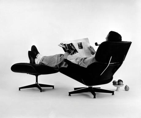 Charles Eames in the plywood Lounge and Ottoman, 1956 Photograph Eames Office