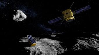 In questa illustrazione: il micro-lander della missione ESA Asteroid Impact Mission appoggiato sul corpo minore (170 metri di diametro) dell’asteroide binario Didymos. Sullo sfondo si scorge il corpo principale, grande circa 800 metri. Crediti: ESA - ScienceOffice.org