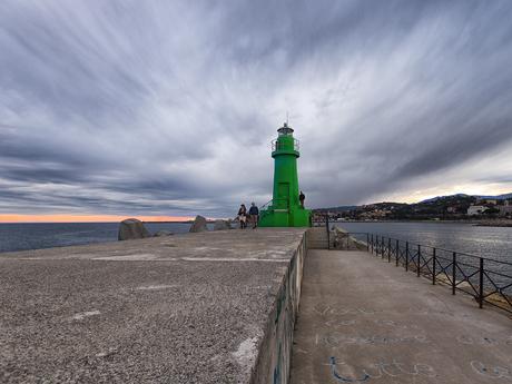 Green Lighthouse and  dark clouds