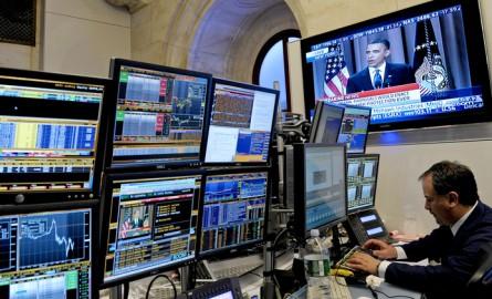 A monitor displays a live broadcast of President Barack Obama speaking about financial regulatory reform as a trader works on the floor of the New York Stock Exchange in New York, U.S., on Thursday, April 22, 2010. Obama called on the financial industr...