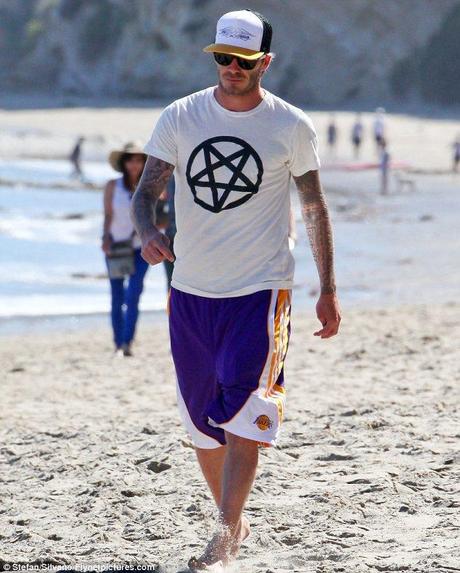 Sign of satan? David Beckham arrived at the beach in a white T-shirt with an inverted pentagram symbol associated with satanists printed on it