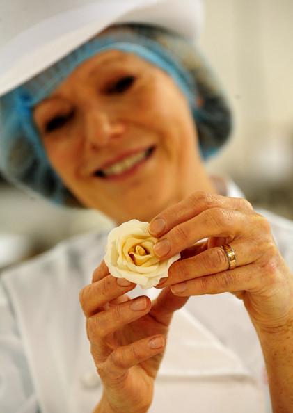 Fiona Cairns Cake designer Fiona Cairns, who has been commissioned by Prince William and Kate Middleton to create a multi-tiered traditional fruit cake for their wedding, holds up a floral cake decoration, on March 24, 2011 in Fleckney, Leicestershire, England. The wedding will take place on April 29, 2011.