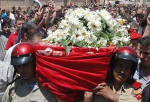 The funeral of a Syrian police officer killed in clashes at Homs