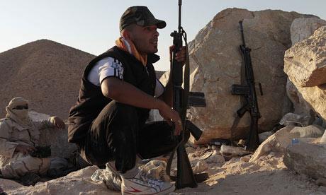 Rebel Libyan fighters face Gaddafi loyalist troops near Bir Ghanem