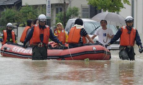 A family is rescued from floodwaters caused by typhoon Roke as it approaches Japan