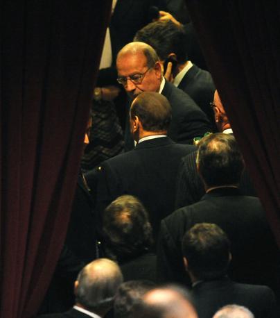 L'uscita di Barlusconi dall'aula di Montecitorio (Ansa)