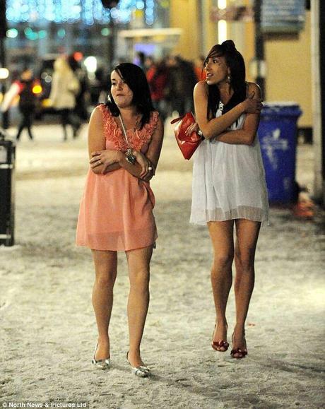 No, I'm not cold, honestly: Geordie lasses try and keep warm on a chilly evening