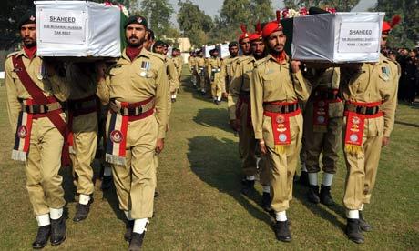 Pakistani soldiers carry the coffins of comrades. 27/11/11