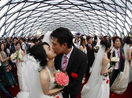 A couple kisses during a mass wedding ceremony at the Taipei Flora Expo Hall in Taiwan